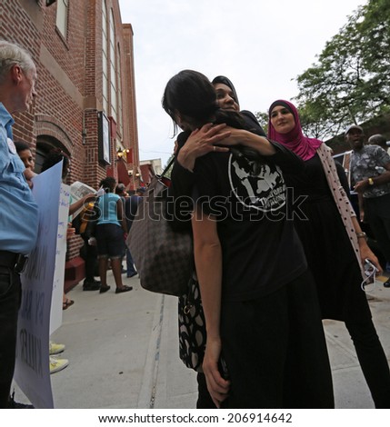 NEW YORK CITY - JULY 23 2014: Funeral services for Eric Garner, the Staten Island resident who died while being taken into custody by NYPD.  Activists embrace outside church