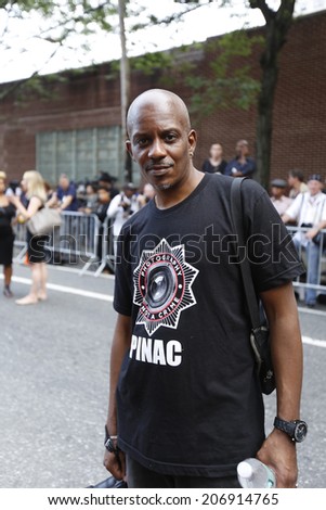NEW YORK CITY - JULY 23 2014: Funeral services for Eric Garner, the Staten Island resident who died while being taken into custody by NYPD.  Activist with PINAC, Photography Is Not A Crime, shirt