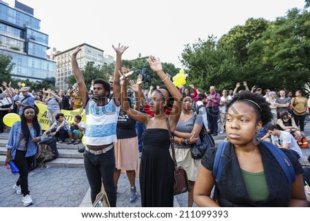 NEW YORK CITY - AUGUST 14 2014: Thousands of New Yorkers responded to Anonymous\'s call for a Day of Rage march & rally to demand justice for the police-related deaths of Michael Brown & Eric Garner