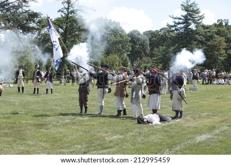 NEW YORK CITY - AUGUST 24 2014: Green-Wood Historic Fund sponsored a reenactment of the Battle of Brooklyn in Greenwood Cemetery, Brooklyn, with displays of musketry, cannon-fire & vintage costumes