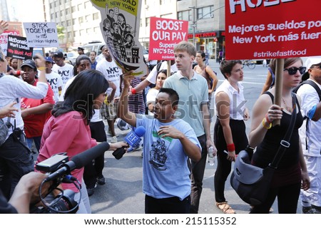 NEW YORK CITY - SEPTEMBER 4 2014: fast food workers and their supporters marched along 8th Ave calling for an increase in the minimum wage.Some attempted to block the street leading to several arrests