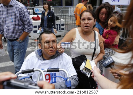 NEW YORK CITY - SEPTEMBER 11 2013: the 13th anniversary of the WTC terror attacks was observed in  Manhattan by first responders & relatives of attack victims. Mauricio Avila & Elva Calle interviewed