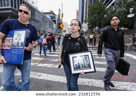 NEW YORK CITY - SEPTEMBER 11 2013: the 13th anniversary of the WTC terror attacks was observed in Lower Manhattan by first responders & relatives of attack victims. Attendees with memorial signs