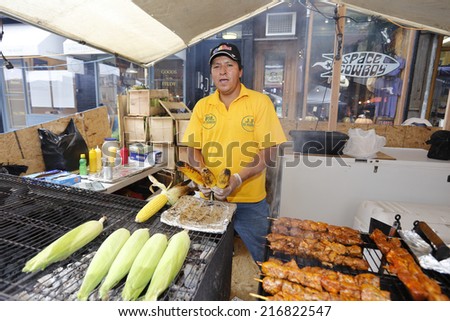 NEW YORK CITY - SEPTEMBER 11 2014: the 88th annual Festival of San Gennaro opened on Mulberry St between Canal & Prince Sts. Elotes, a Mexican-Central American specialty, on the grill