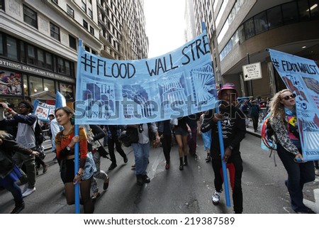 NEW YORK CITY - SEPTEMBER 22 2014: Flood Wall Street demonstrators marched from Battery Park to Broadway & Morris St for a sit down before proceeding to Wall St where NYPD made numerous arrests