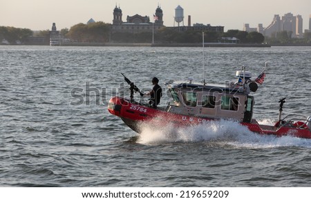 NEW YORK CITY - SEPTEMBER 10 2014: US Coast Guard Response Boat Small Class patrolling New York Harbor just past Ellis Island. The RB-S is noted for  maneuverability with a top speed over 40 knots.