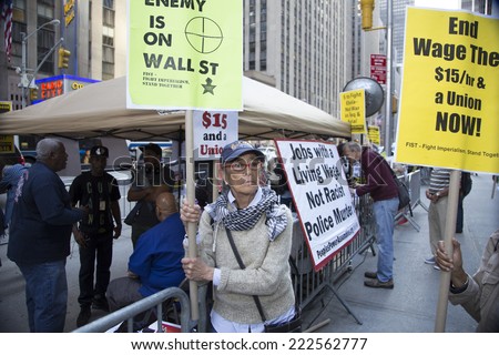 NEW YORK CITY - OCTOBER 8 2014: Occupy The World Business Forum held a rally in front of Radio City Music Hall demanding a higher minimum wage & more workers\' rights during the World Business Forum