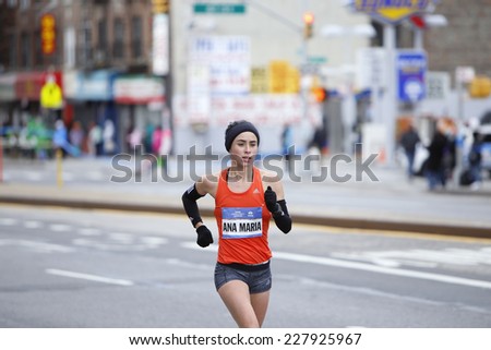 NEW YORK CITY - NOVEMBER 2 2014: the 43rd annual NYC Marathon saw more than 50,000 entrants race through all five boroughs. Women's division elite runner passes mile four on Fourth Avenue in Brooklyn