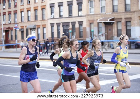 NEW YORK CITY - NOVEMBER 2 2014: the 43rd annual NYC Marathon saw more than 50,000 entrants race through all five boroughs. Women's elite pack crosses mile four in Sunset Park, Brooklyn