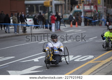 NEW YORK CITY - NOVEMBER 2 2014: the 43rd annual NYC Marathon saw more than 50,000 entrants race through all five boroughs. Wheelchair division competitors pass mile four in Brooklyn