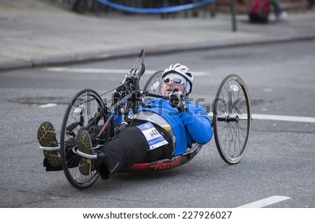 NEW YORK CITY - NOVEMBER 2 2014: the 43rd annual NYC Marathon saw more than 50,000 entrants race through all five boroughs. Wheelchair division competitor passes mile four in Brooklyn