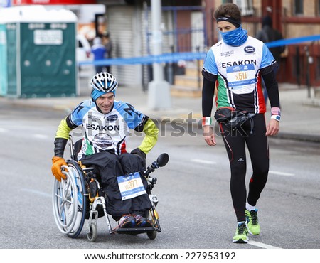 NEW YORK CITY - NOVEMBER 2 2014: the 43rd annual New York City Marathon saw more than 50,000 entrants run through all five boroughs. Wheelchair division competitors pass mile four in Sunset Park