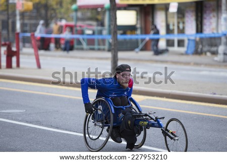 NEW YORK CITY - NOVEMBER 2 2014: the 43rd annual New York City Marathon saw more than 50,000 entrants run through all five boroughs. Wheelchair division competitors pass mile four in Sunset Park