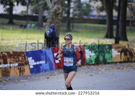 NEW YORK CITY - NOVEMBER 2 2014: the 43rd annual New York City Marathon saw more than 50,000 entrants run through all five boroughs. Women\'s elite runner Valeria Straneo of Italy enters Central Park