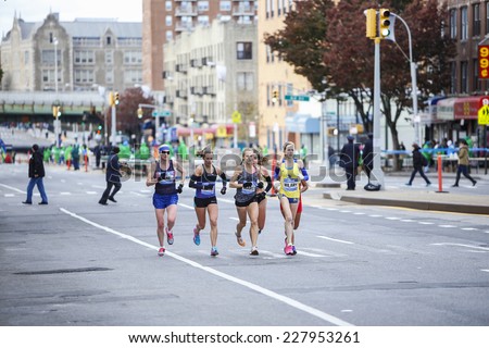 NEW YORK CITY - NOVEMBER 2 2014: the 43rd annual New York City Marathon saw more than 50,000 entrants run through all five boroughs. Elite runners in pack pass mile four in Sunset Park, Brooklyn