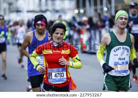 NEW YORK CITY - NOVEMBER 2 2014: the 43rd annual New York City Marathon saw more than 50,000 entrants run through all five boroughs. Female runner along 59th Street approaching the finish line