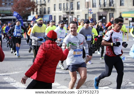 NEW YORK CITY - NOVEMBER 2 2014: the 43rd annual New York City Marathon saw more than 50,000 entrants run through all five boroughs. Volunteers pass water in cups to runners by mile four in Brooklyn
