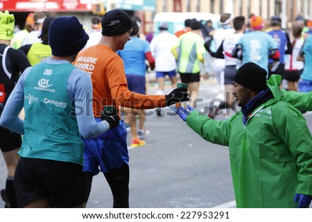 NEW YORK CITY - NOVEMBER 2 2014: the 43rd annual New York City Marathon saw more than 50,000 entrants run through all five boroughs. Passing out water to runners along Fourth Avenue