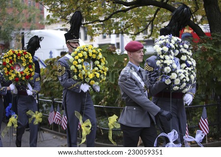 NEW YORK CITY - NOVEMBER 11 2014: the 95th annual Veteran's Day parade along Fifth Avenue is the largest Nov 11 celebration in the United States. Honor guard carrying wreath to Eternal Light Monument