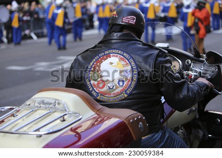 NEW YORK CITY - NOVEMBER 11 2014: the 95th annual Veteran\'s Day parade along Fifth Avenue is the largest Nov 11 celebration in the United States. Veterans based motorcycle club jacket & rider