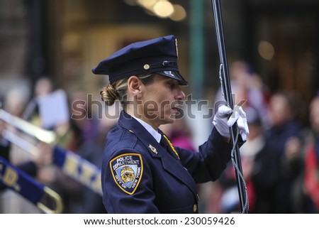 NEW YORK CITY - NOVEMBER 11 2014: the 95th annual Veteran\'s Day parade along Fifth Avenue is the largest Nov 11 celebration in the United States. NYPD marching band leader, Amy Pape, with baton