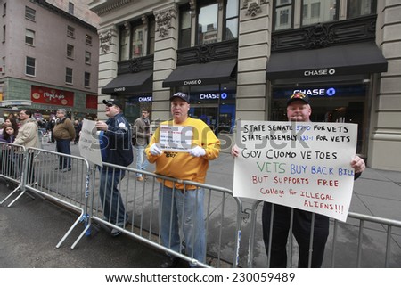 NEW YORK CITY - NOVEMBER 11 2014: the 95th annual Veteran\'s Day parade along Fifth Avenue is the largest Nov 11 celebration in the United States. Protesting against Gov Cuomo\'s veto of veteran\'s bills