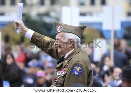 NEW YORK CITY - NOVEMBER 11 2014: the 95th annual Veteran's Day parade along Fifth Avenue is the largest Nov 11 celebration in the United States. World War ii veteran stands at Madison Square Park