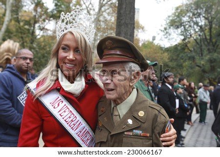 NEW YORK CITY - NOVEMBER 11 2014: the 95th annual Veteran\'s Day parade along Fifth Avenue is the largest Nov 11 celebration in the United States. Miss Veteran America, Allaina Guitron, with veteran