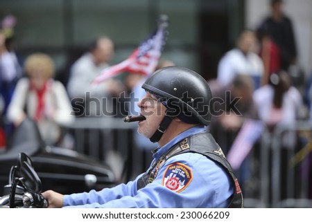 NEW YORK CITY - NOVEMBER 11 2014: the 95th annual Veteran\'s Day parade along Fifth Avenue is the largest Nov 11 celebration in the United States. FDNY motorcycle club, Fire Riders, members with cigar
