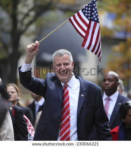 NEW YORK CITY - NOVEMBER 11 2014: the 95th annual Veteran\'s Day parade along Fifth Avenue is the largest Nov 11 celebration in the United States. NYC Mayor Bill De Blasio with US flag