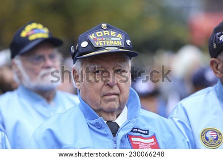 NEW YORK CITY - NOVEMBER 11 2014: the 95th annual Veteran\'s Day parade along Fifth Avenue is the largest Nov 11 celebration in the United States. Korean War Veterans in blue at Madison Square Park