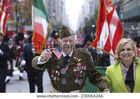 NEW YORK CITY - NOVEMBER 11 2014: the 95th annual Veteran\'s Day parade along Fifth Avenue is the largest Nov 11 celebration in the United States.Representative Carolyn Maloney marching with veteran