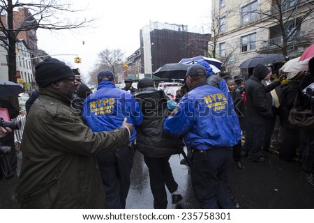NEW YORK CITY - DECEMBER 6 2014: funeral services for Akai Gurley, shot to death by NYPD rookie officer Peter Liang, were held at Brown Baptist Church in Brooklyn. Escorting agitated man off premesis