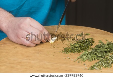 Making herb butter/slicing garlic clove
