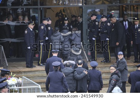 NEW YORK CITY - JANUARY 4 2015: several thousand police officers from all over North America attended funeral services for slain NYPD officer Wenjian Liu in Brooklyn. Wenjian Liu family escorted in