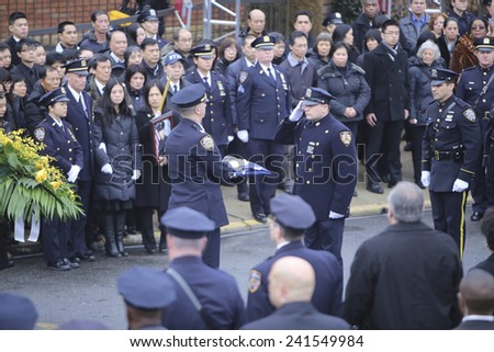 NEW YORK CITY - JANUARY 4 2015: several thousand police officers from all over North America attended funeral services for slain NYPD officer Wenjian Liu in Brooklyn. Folding NYPD flag.
