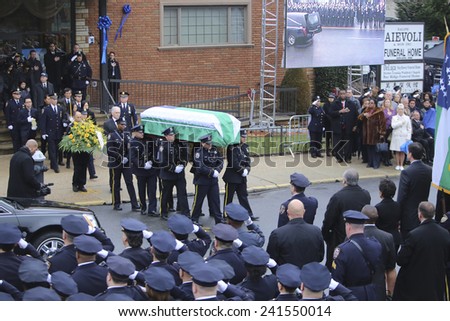 NEW YORK CITY - JANUARY 4 2015: several thousand police officers from all over North America attended funeral services for slain NYPD officer Wenjian Liu in Brooklyn. Family follows flag-draped coffin