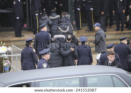NEW YORK CITY - JANUARY 4 2015: several thousand police officers from all over North America attended funeral services for slain NYPD officer Wenjian Liu in Brooklyn. Liu family escorted into mortuary