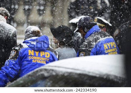 NEW YORK CITY - JANUARY 6 2015: funeral services were held for former New York governor Mario Cuomo at St. Ignatius Loyola Church on Manhattan's Upper East Side. NYPD assisting elderly mourner