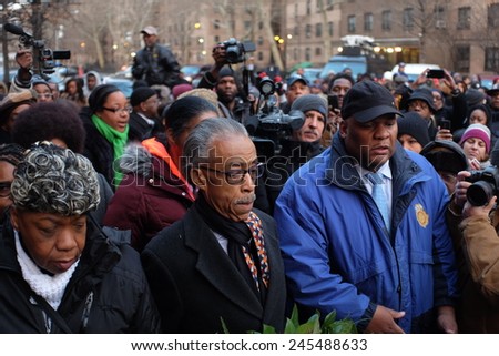 NEW YORK CITY - JANUARY 19 2015: Rev Al Sharpton, accompanied by Eric Garner\'s family, placed wreaths on the site where NYPD officers Wenjian Liu & Rafael Ramos were slain. Moment of silence