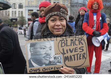NEW YORK CITY - JANUARY 19 2015: several hundred activists gathered at Union Square Park prior to starting the Four Mile March on Martin Luther King\'s birthday. Activist with Black Lives Matter sign