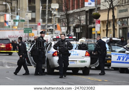 NEW YORK CITY - JANUARY 25 2015: a shooting at the Home Depot store in Chelsea left two employees dead in what is being called a murder-suicide. Uniformed NYPD officers on 23rd Street outside store