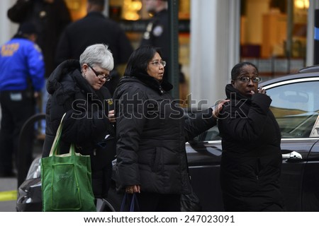 NEW YORK CITY - JANUARY 25 2015: a shooting at the Home Depot store in Chelsea left two employees dead in what is being called a murder-suicide. Women present during shooting leave the scene