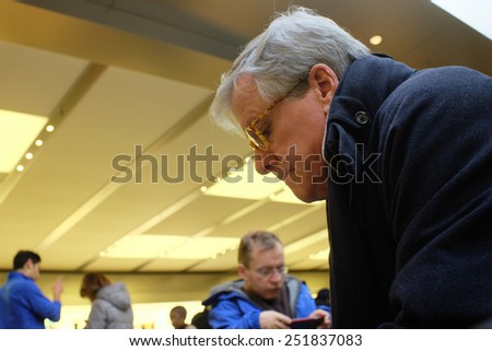 NEW YORK CITY - FEBRUARY10 2015: Apple closed the NYSE with a market capitalization of $705 billion dollars, the first company ever to breach $700 billion. Waiting for service at Apple store.