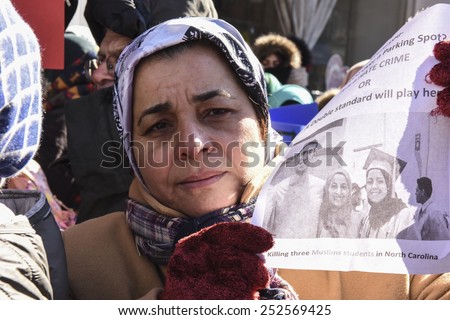 NEW YORK CITY - FEBRUARY 13 2015: Members of the Muslim community staged a vigil to call for justice in the killing of three Muslim Chapel Hill students. Woman with picture of slain students