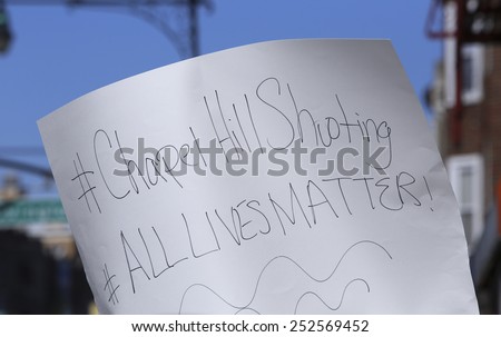 NEW YORK CITY - FEBRUARY 13 2015: Members of the Muslim community staged a vigil to call for justice in the killing of three Muslim Chapel Hill students. Hand-lettered sign \