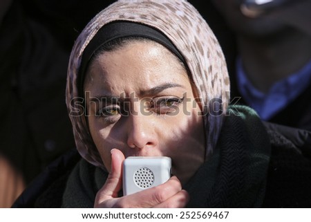 NEW YORK CITY - FEBRUARY 13 2015: Members of the Muslim community staged a vigil to call for justice in the killing of three Muslim Chapel Hill students. Female activist addresses rally