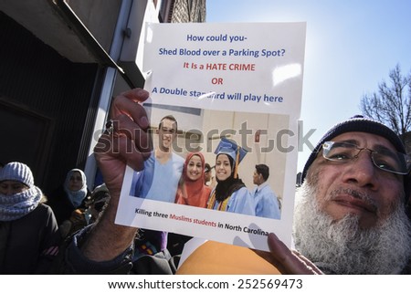 NEW YORK CITY - FEBRUARY 13 2015: Members of the Muslim community staged a vigil to call for justice in the killing of three Muslim Chapel Hill students. Activist with picture of slain students