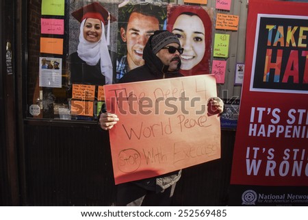 NEW YORK CITY - FEBRUARY 13 2015: Members of the Muslim community staged a vigil to call for justice in the killing of three Muslim Chapel Hill students. Activist with hand-lettered sign