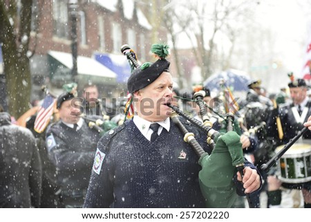 NEW YORK CITY - MARCH 1 2015: the 15th annual St. Pat\'s For All parade, an alternative to the Fifth Ave parade, took place in driving snow in Sunnyside, Queens. FDNY Emerald Society marching band